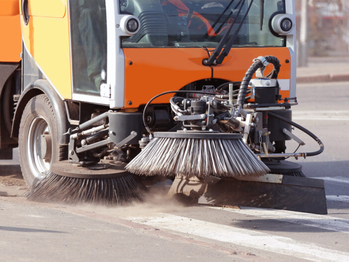 Municipal car for cleaning roads and sidewalks outdoors