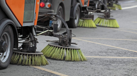 Side view of street sweepers on street